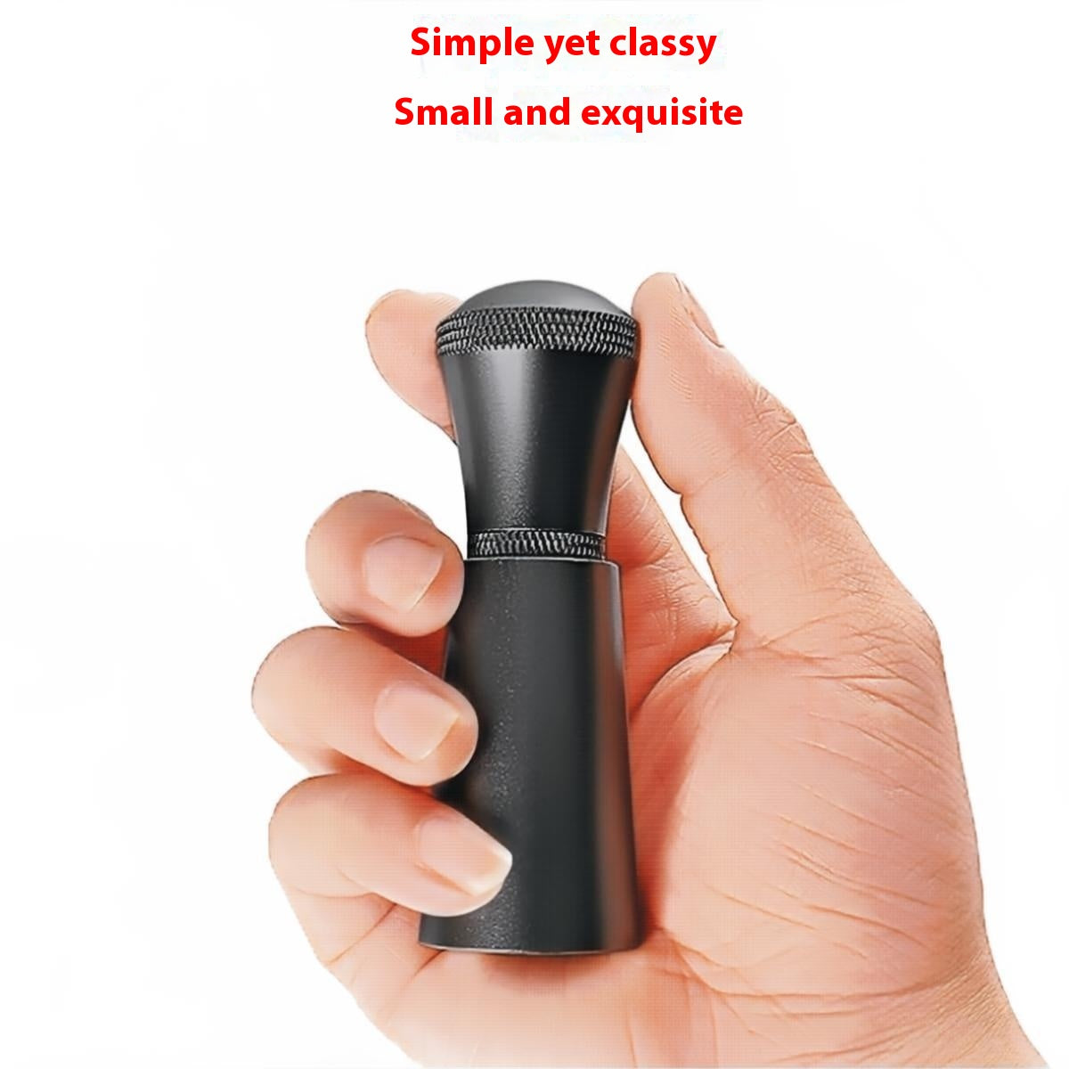 Hand holding the compact black coffee distribution tool to show its size