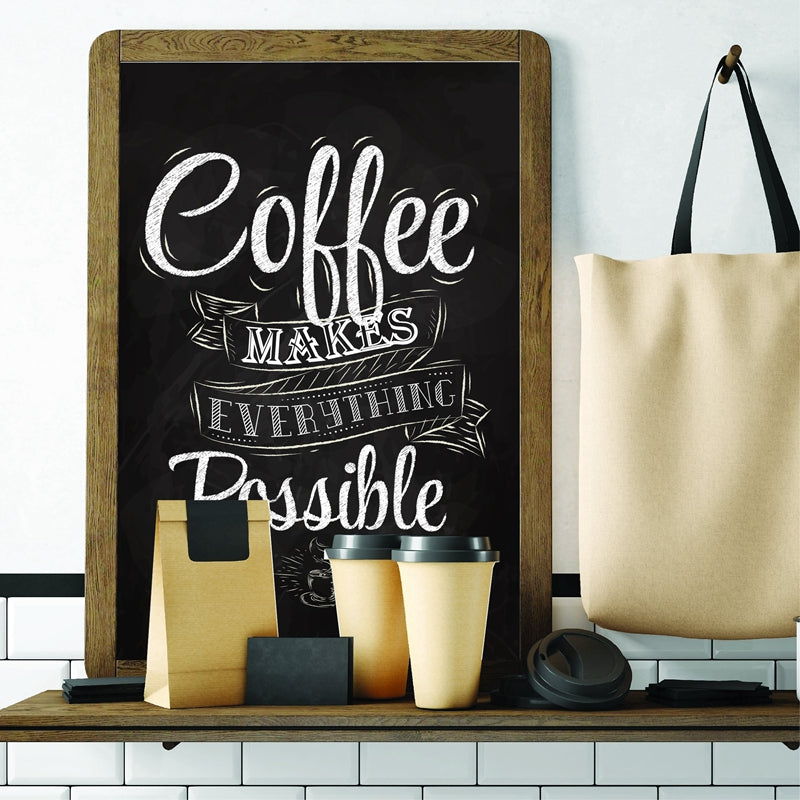 Print in a wood frame on a shelf styled with a tote bag, coffee cups, and paper bags