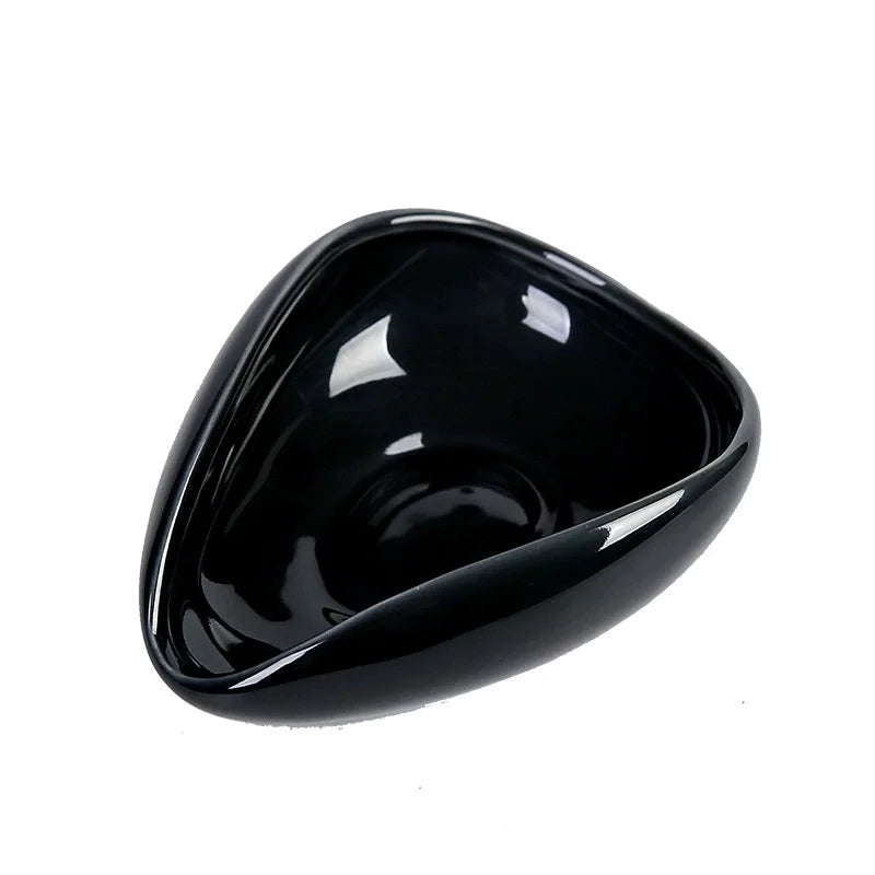 Pouring coffee beans from ceramic dosing cup into grinder