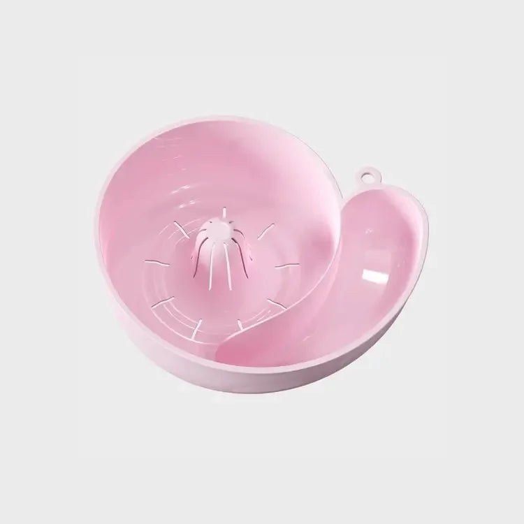 Pink snail-shaped fruit washing basket on a plain white background