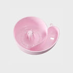 Pink snail-shaped fruit washing basket on a plain white background