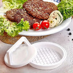 Burger press beside a plate of grilled meat patties with lettuce, tomato, and onion