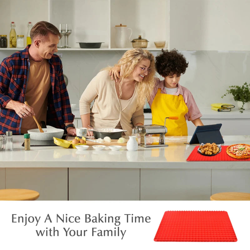 Family baking together in a kitchen, with cooked bites and a pizza resting on the red pyramid mat