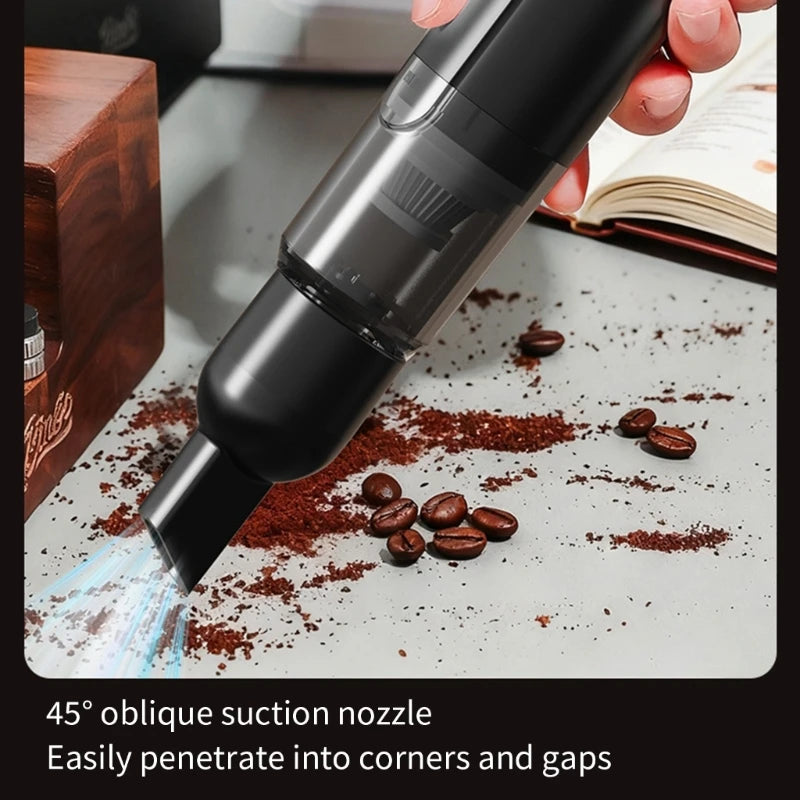 Hand using the cleaner's angled nozzle to vacuum spilled coffee grounds and beans off a counter