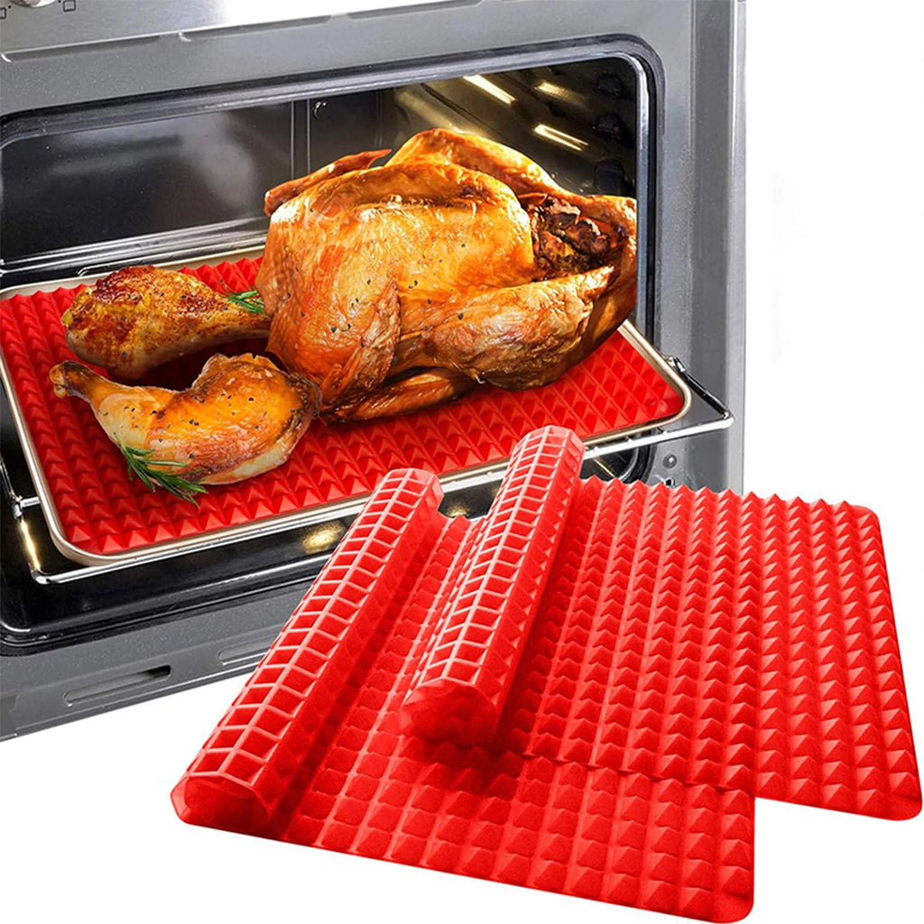 Roasted turkey and chicken drumsticks on a red pyramid mat in the oven, with a rolled mat in the foreground
