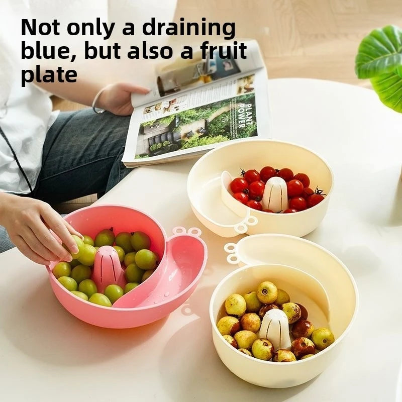 Person picking grapes from a pink snail basket, with cream baskets of cherry tomatoes and berries nearby