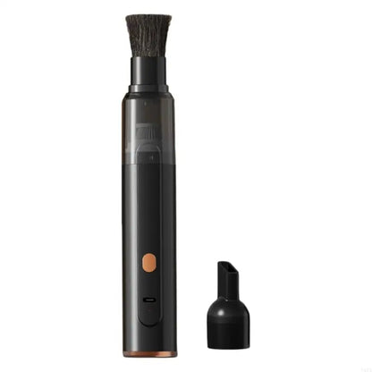 Black coffee grinder cleaner with brush head and nozzle attachment on a white background