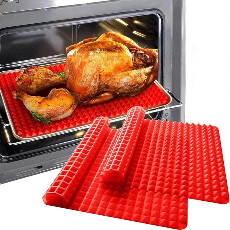Whole roasted chicken in the oven on the red pyramid mat, with a rolled mat shown in front